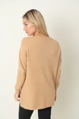 Buzo camel de viscosa y poliamida, con cuello redondo, corte holgado, tajos laterales y botones decorativos.