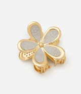 Pinza para el pelo en forma de flor con acabado dorado y detalles de brillo plateado en los pétalos. Cuenta con un sistema de agarre de dientes metálicos.