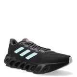Championes de running Adidas Switch Run para mujer, en color negro con detalles en celeste y lila. Presentan una parte superior de malla transpirable y una entresuela de EVA con diseño de rebajes característico, ofreciendo estabilidad y amortiguación.