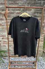 Remera azul con efecto lavado, de corte holgado y manga corta. Estampa en la espalda con flores de colores y la frase "Más flores, menos drama".