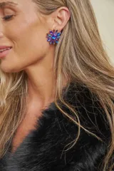 Caravana de diseño floral con cristales en tonos azul y violeta, con base metálica dorada.