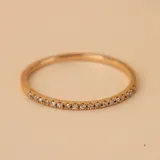 Anillo doble en oro 18k, compuesto por una alianza fina con engaste de brillantes y una alianza lisa con un brillante central.