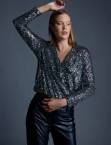 Blusa de microtul bordada con lentejuelas plateadas, marca Ninety. Escote en V cruzado y ruedo elastizado.