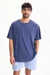 Remera oversize de manga corta y cuello redondo, confeccionada en algodón con acabado lavado estilo vintage.