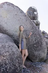 Vestido corto ajustado de manga larga con cuello redondo, confeccionado en lycra ecofriendly con estampado geométrico de flores pequeñas en tonos verdes y naranjas.