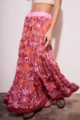 Falda larga de viscosa con estampado de animales y plantas en tonos marrón, naranja y rosa. Tiene cintura elástica rosa.