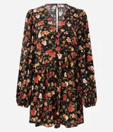 Enterito corto de viscosa con estampado floral sobre fondo negro, escote en V, mangas largas con volumen y puños ajustados.