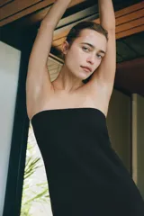 Vestido largo negro de viscosa, con escote recto tipo palabra de honor y hombros descubiertos, de corte recto y ajuste con cierre lateral oculto.