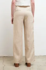 Pantalón de vestir color beige, de corte recto y tiro alto, confeccionado en lino 100% con bolsillos laterales.