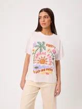 Remera de algodón marca Rusty, color blanco, de corte holgado, con cuello redondo, mangas cortas y estampado frontal colorido de temática tropical.