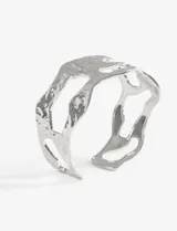 Pulsera rígida de acero quirúrgico con diseño irregular y calado, de acabado brillante.