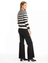 Buzo de tejido acanalado con diseño de rayas horizontales en color negro y beige, cuello redondo y manga larga.