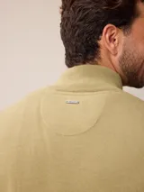 Sweater de punto color gris, con cuello alto y cierre frontal parcial con detalle de tela a cuadros en el interior. Presenta puños y ruedo acanalados y logo bordado en el pecho.
