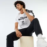 Camiseta blanca de manga corta con estampado de texto negro.