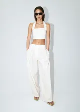 Pantalón de corte recto y tiro regular, color blanco, con bolsillos laterales y pinzas en la parte delantera.