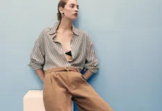 Short de gabardina marrón de tiro medio, diseño recto tipo bermuda, con pinzas en la parte delantera, bolsillos laterales y cinturón ajustable incorporado.