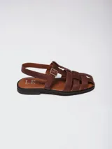 Sandalias tipo pescador de cuero marrón, con diseño de tiras entrelazadas, cierre con hebilla lateral y suela plana.
