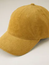 Gorra de béisbol color ocre, confeccionada en pana con visera curva y botón superior.