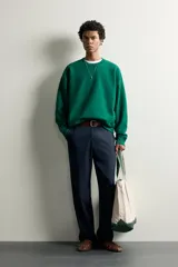 Sudadera de corte regular fit en color verde, con cuello redondo, manga larga raglán y acabados en rib elástico en cuello, puños y dobladillo.