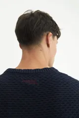 Sweater color marrón claro, tejido con combinación de puntos y rib en puños. Bordado de marca en la manga.