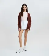 Cardigan de punto básico, con mangas largas y sisa desplazada. Presenta un diseño abierto sin botones, confeccionado en un tejido de punto ligero y versátil.