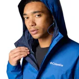 Campera impermeable Columbia modelo Watertight II, color azul, con capucha ajustable, cierre frontal, bolsillos laterales con cremallera y puños ajustables. Cuenta con tecnología Omni-Tech para mayor protección contra la lluvia.