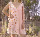 Vestido corto color verde claro, con escote en V y tiras anchas que se atan en los hombros.