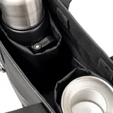Cartera tipo tote de diseño estructurado en color negro, confeccionada en material sintético. Cuenta con doble asa superior fija, correa larga regulable y extraíble, bolsillo frontal con cierre metálico y logo circular grabado en la parte inferior.