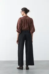 Jean de corte amplio y tiro medio, con diseño de costuras verticales frontales y bolsillos laterales tipo parche. Presenta un acabado en tono azul clásico.