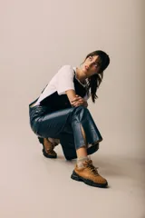 Zapatillas marrones con cordones y suela de goma negra.