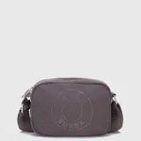 Bolso tipo bandolera de lona en color gris oscuro, con diseño compacto y cierre superior. Presenta un logo circular grabado en el frente y correa ajustable con el nombre de la marca.