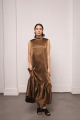 Vestido largo color ocre con estampado de cuadrados dorados, cuello alto y corte amplio. Incluye viso liso al tono.