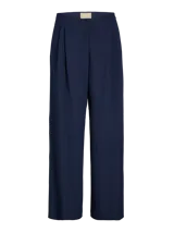 Pantalón sastrero de tiro medio color azul marino, con cierre de botón y cremallera, pierna ancha y largo completo. Confeccionado en tejido plano.