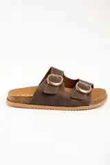 Sandalias de doble hebilla en cuero marrón con acabado texturizado, plantilla cómoda y suela tipo corcho con base de goma antideslizante.