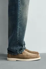 Mocasín casual de hombre, color azul marino, con parte superior de serraje (gamuza) y suela de goma a contraste color beige. Presenta un detalle de bordón cosido en la pala.