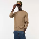 Sweater de punto con textura fantasía, cuello redondo y mangas largas con puños acanalados.
