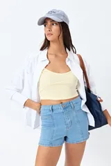 Short de jean de tiro alto, color celeste claro, con bolsillos frontales y traseros, y cierre frontal con botón metálico.