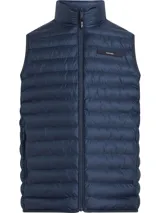 Chaleco acolchado de nailon reciclado color azul marino, con cuello alto y cierre frontal de cremallera. Presenta un corte regular, bolsillos laterales con cremallera e insignia con el logo de Calvin Klein en el pecho. Cuenta con aislante de plumas sintéticas y diseño plegable.