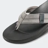 Ojotas Reef Cushion Phantom, base negra y tiras grises con logo de la marca.