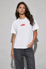 Remera blanca de manga corta y cuello redondo, con estampa en el pecho con la palabra "chill" en color rojo.