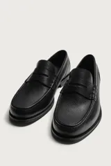 Mocasín de vestir para hombre confeccionado en piel con acabado abatanado, de color marrón. Cuenta con detalle de antifaz en el empeine, horma redonda, plantilla interior de piel y suela a contraste con ligero tacón.