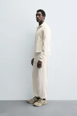 Sudadera roja de corte regular, con cuello alto y cierre frontal de cremallera. Manga larga y terminaciones en rib.