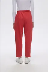 Pantalón tipo babucha de corte recto, confeccionado en tejido con felpa, con cintura elástica y cordón de ajuste frontal.