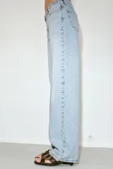 Jeans de tiro bajo con diseño de cinco bolsillos y pernera recta. Cierre frontal con cremallera y botón metálico.