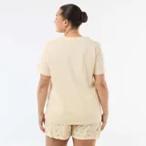 Pijama corto de dos piezas en color amarillo, compuesto por una camiseta lisa de manga corta con un pequeño estampado en el pecho y un short con patrón a rayas verticales y estampado de cerezas.