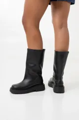Bota de caña media confeccionada en cuero negro, con suela track de goma dentada y puntera redondeada.