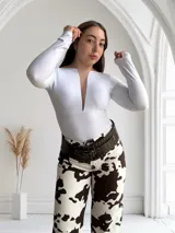 Body blanco de mangas largas con escote en V pronunciado.
