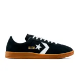 Championes Converse Classic Trainer negros de gamuza con detalles en blanco y suela de goma color caramelo. Presentan el logo All Star en dorado y el chevron característico de la marca en blanco.