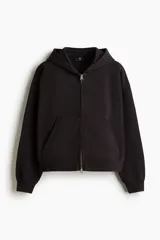 Campera con capucha y cierre de cremallera metálica, corte oversize, hombros caídos y bolsillos delanteros tipo canguro, en tejido negro de algodón.