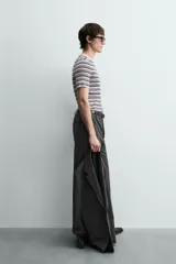 Camiseta de punto canalé slim fit, con cuello redondo y manga corta. Presenta un estampado de rayas horizontales en blanco, negro y rosado.